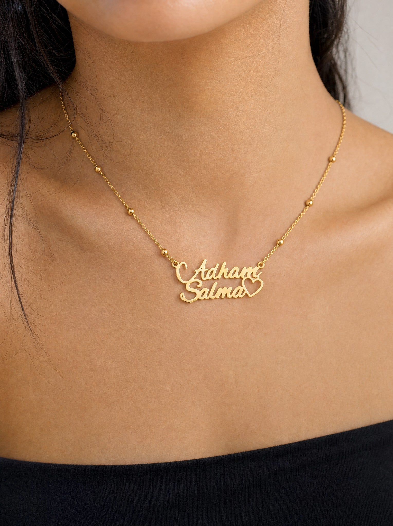 Editorial — SOLENE. Names & Heart Necklace in 21k gold — on model